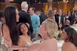 Demi Moore and Elle Fanning speaking at the Golden Globes while Kylie Jenner looks on